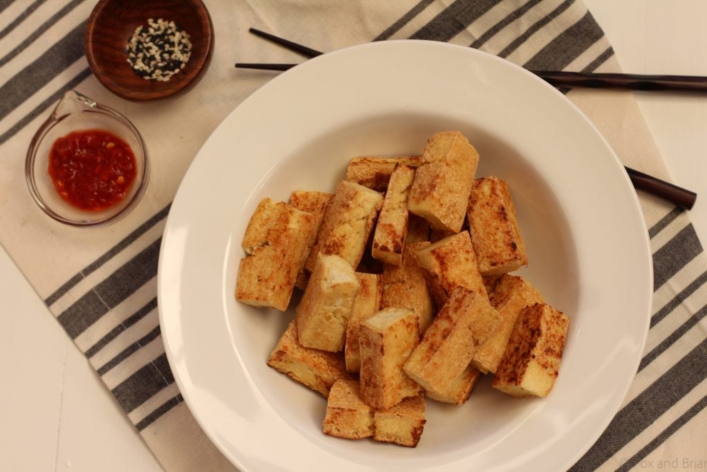The first thing you need to do is buy the right kind of tofu. The kind of tofu you chose will depend on how you want to use it. I usually want my tofu to be used in things like stir fries and other dishes where it is the protein star instead of meat. So I always choose EXTRA FIRM tofu. Definitely don’t get silken tofu unless you are wanting to put it in your smoothie or make faux scrambled eggs or something. Extra firm tofu is better than just firm, so try to get that if you can for this application.