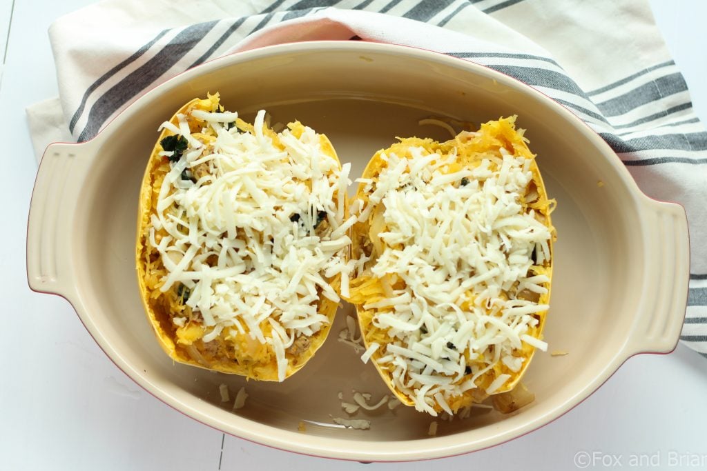 Sausage and Kale Spaghetti Squash Boats! So good! And healthy! Spicy Sausage and Garlicky Kale all topped with melty cheese make this low carb and gluten free meal perfectly satisfying.