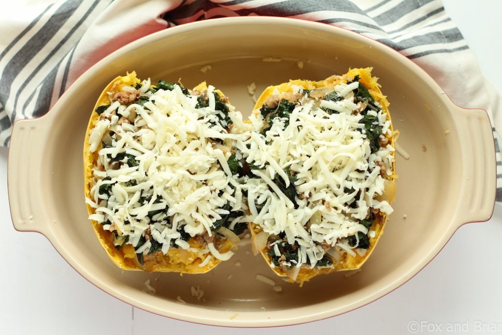 Sausage and Kale Spaghetti Squash Boats! So good! And healthy! Spicy Sausage and Garlicky Kale all topped with melty cheese make this low carb and gluten free meal perfectly satisfying.