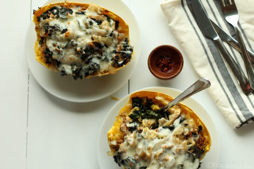 Sausage and Kale Spaghetti Squash Boats! So good! And healthy! Spicy Sausage and Garlicky Kale all topped with melty cheese make this low carb and gluten free meal perfectly satisfying.