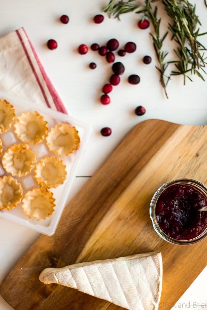 Cranberry Brie Mini Tarts. These easy, 3 ingredients appetizers are perfect for any holiday party that you will be hosting or attending. Buttery brie and sweet tart cranberry sauce in a crispy shell make adorable bite sized appetizers.