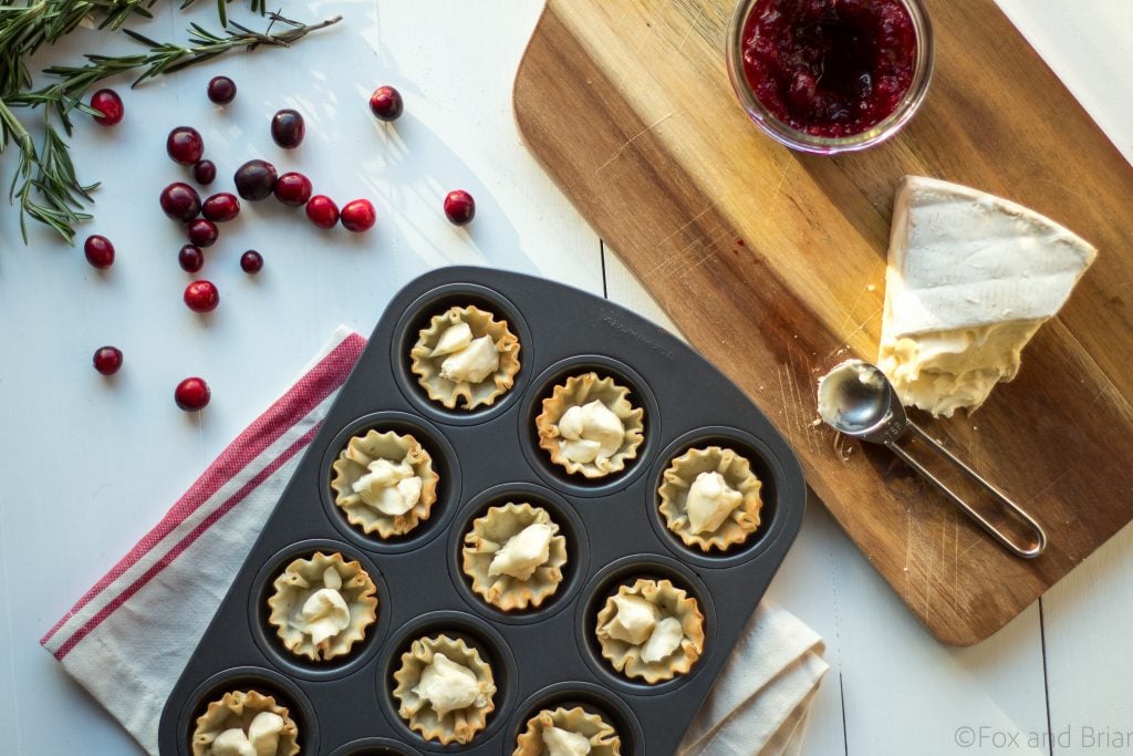 Cranberry Brie Mini Tarts. These easy, 3 ingredients appetizers are perfect for any holiday party that you will be hosting or attending. Buttery brie and sweet tart cranberry sauce in a crispy shell make adorable bite sized appetizers.