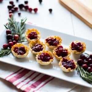 Cranberry Brie Mini Tarts. These easy, 3 ingredients appetizers are perfect for any holiday party that you will be hosting or attending. Buttery brie and sweet tart cranberry sauce in a crispy shell make adorable bite sized appetizers.