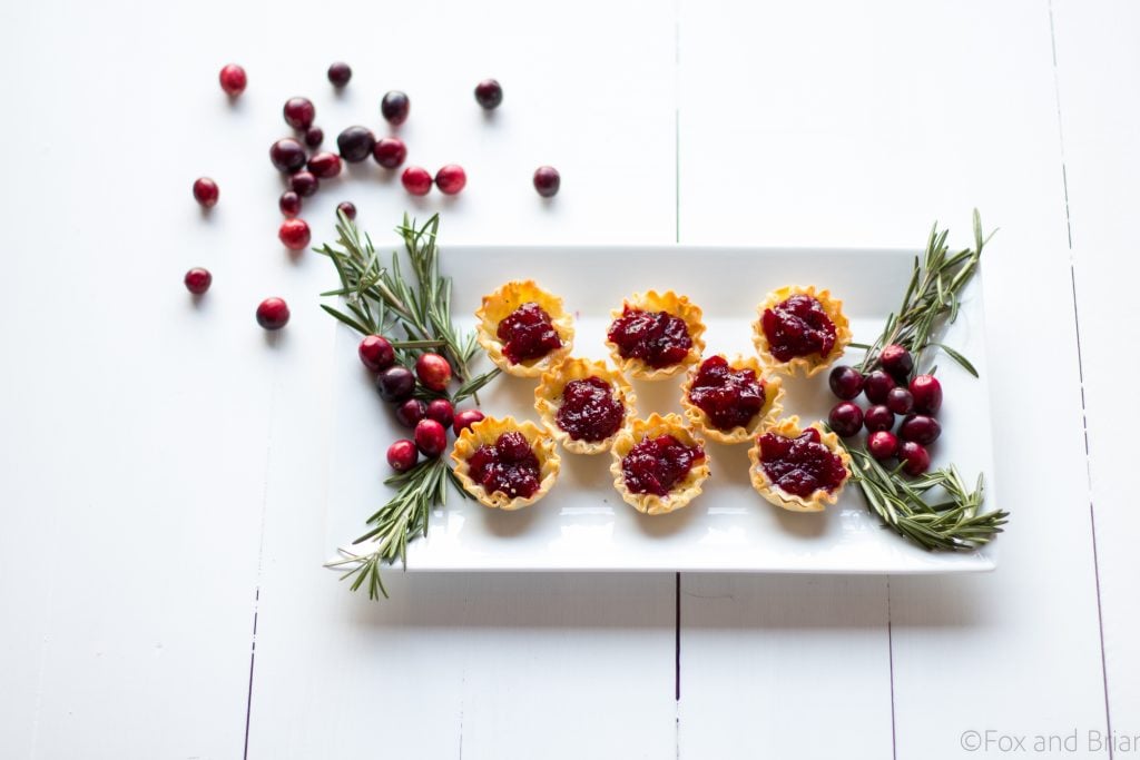 Cranberry Brie Mini Tarts. These easy, 3 ingredients appetizers are perfect for any holiday party that you will be hosting or attending. Buttery brie and sweet tart cranberry sauce in a crispy shell make adorable bite sized appetizers.