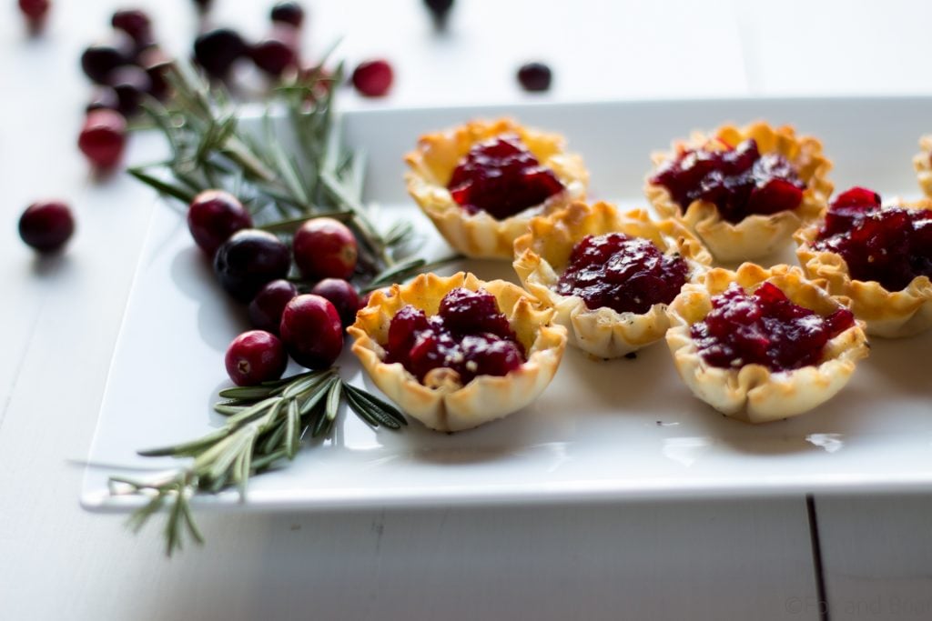 Cranberry Brie Mini Tarts. These easy, 3 ingredients appetizers are perfect for any holiday party that you will be hosting or attending. Buttery brie and sweet tart cranberry sauce in a crispy shell make adorable bite sized appetizers.