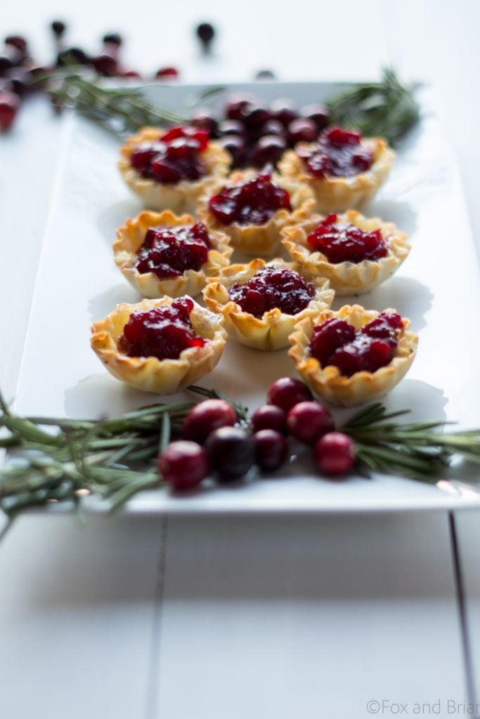 Cranberry Brie Mini Tarts. These easy, 3 ingredients appetizers are perfect for any holiday party that you will be hosting or attending. Buttery brie and sweet tart cranberry sauce in a crispy shell make adorable bite sized appetizers.