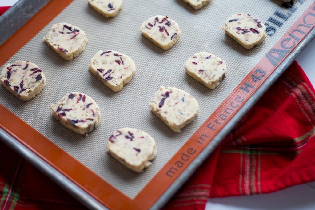 Cranberry Orange and Pecan Shortbread cookies. These easy, slice and bake cookies are flavored with orange zest, vanilla, cranberries and pecans. They are the perfect holiday cookies to give away or keep for yourself!