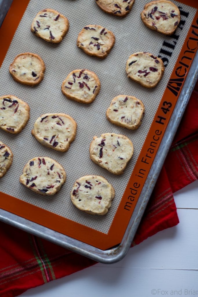 Cranberry Orange and Pecan Shortbread cookies. These easy, slice and bake cookies are flavored with orange zest, vanilla, cranberries and pecans. They are the perfect holiday cookies to give away or keep for yourself!