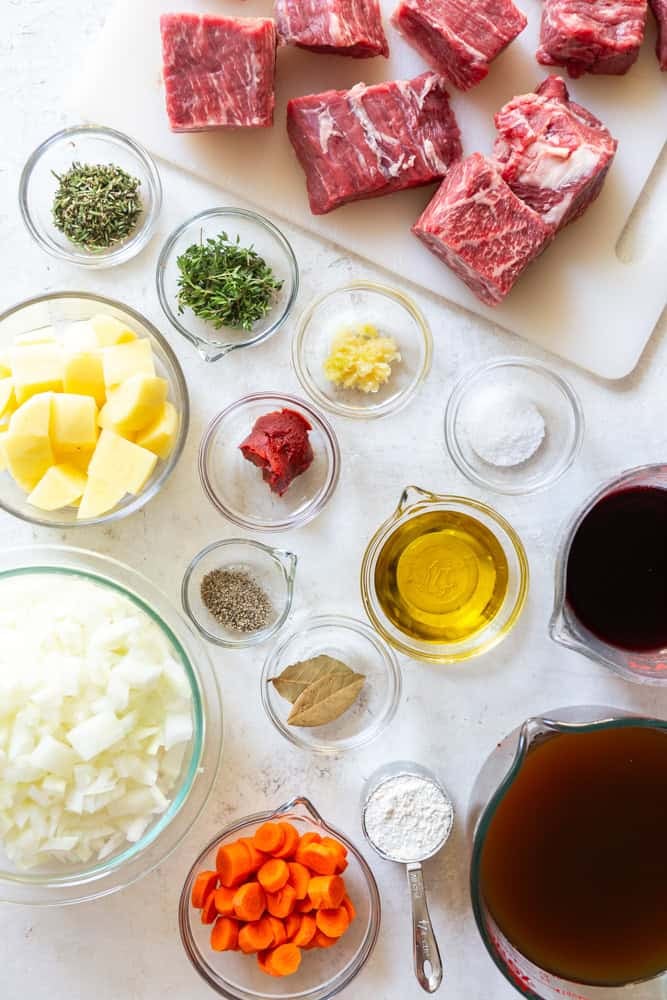 Ingredients for Red Wine Beef Stew - Chuck roast, onions, potatoes, carrots, red wine, beef broth, rosemary, thyme, garlic, bay leaf, sat, pepper, olive oil, flour