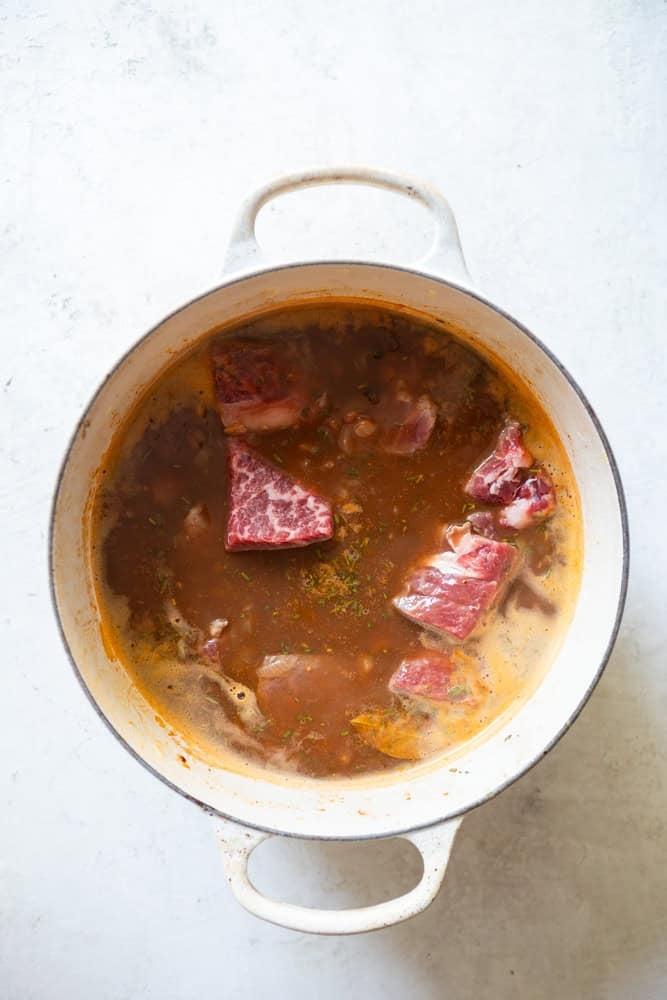 Red Wine Beef stew before cooking - meat is added to pot without browning it first, it will brown in the oven.