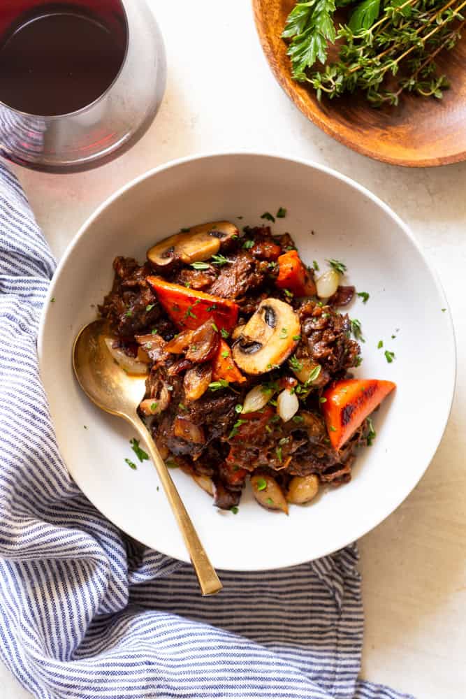 Red Wine Beef stew with potatoes and carrots in a white bowl