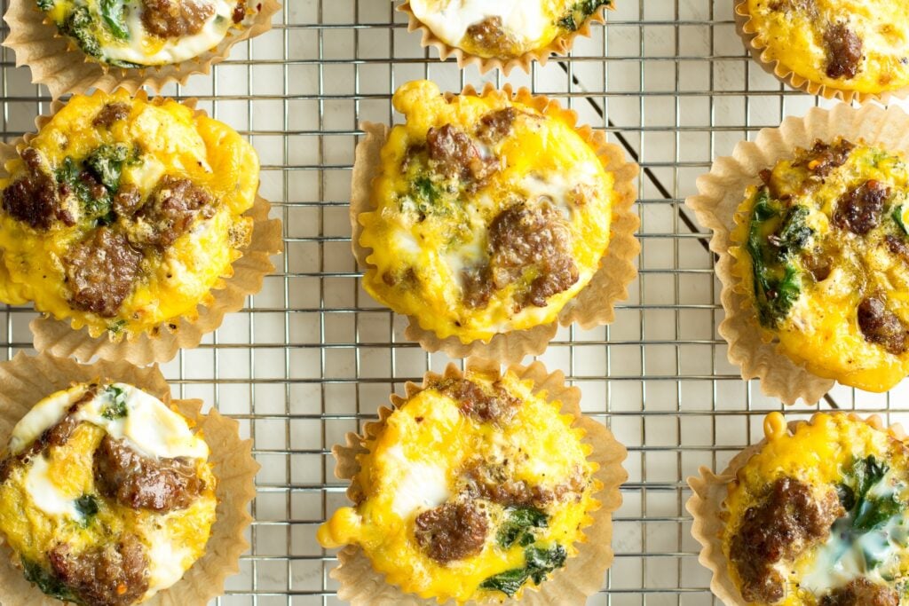 These sausage and kale egg make ahead egg muffins are a low carb, grain free, high protein breakfast that you can make ahead and store in the fridge., On busy mornings, just heat them up and have a quick healthy breakfast.