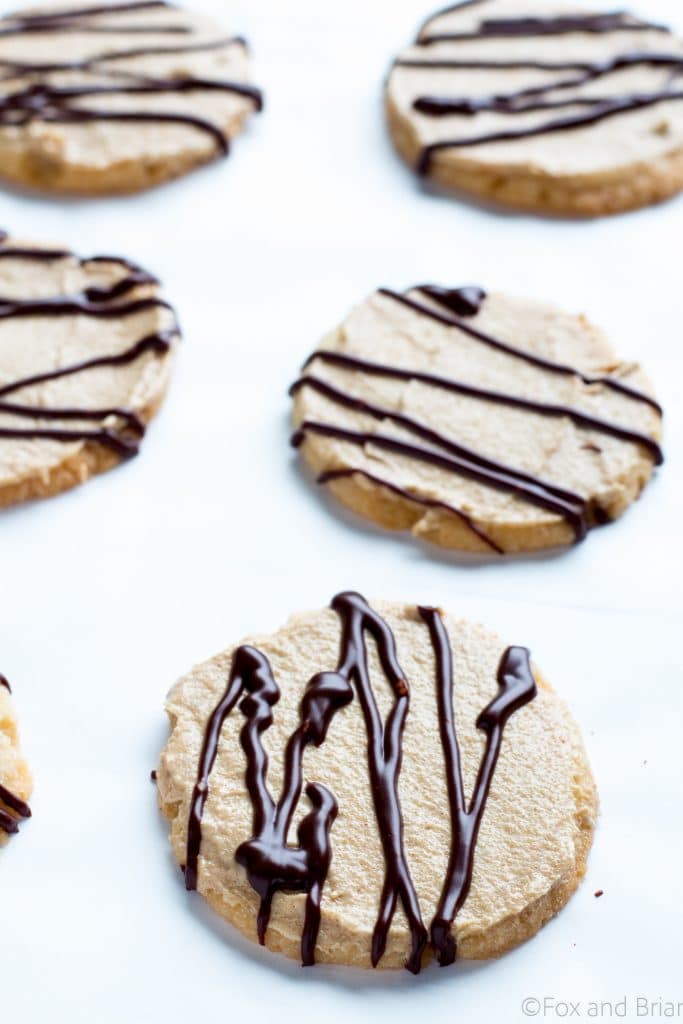 These buttery, delicate vanilla cookies are topped with a whipped peanut butter cream and then drizzled with a rich chocolate glaze.