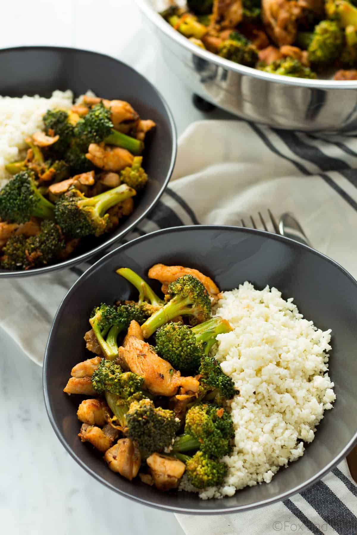 This Buffalo Chicken and Broccoli Bowl is fast, easy and flavorful. Chicken and broccoli in a buffalo sauce, served over cauliflower rice makes a gluten free, low carb, high protein, paleo and whole 30 friendly meal!