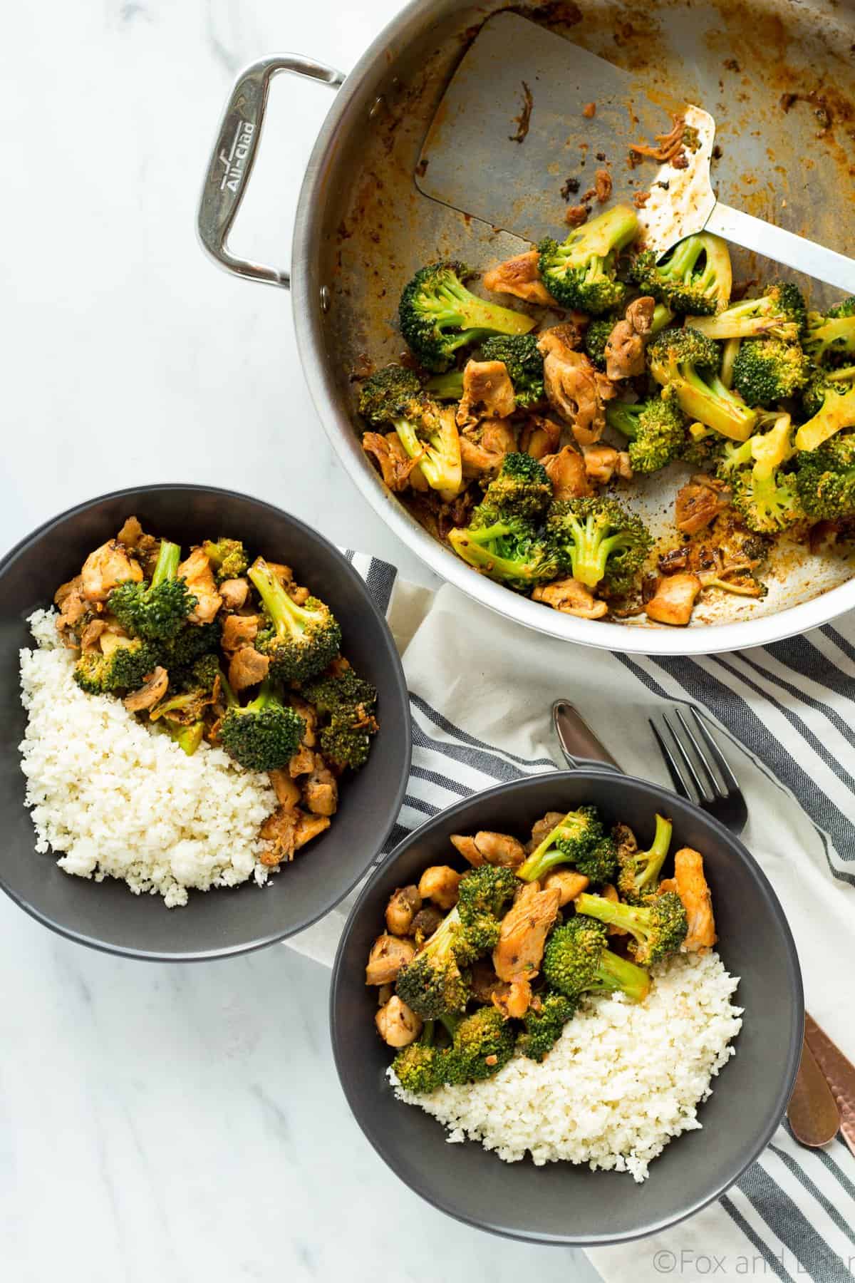 This Buffalo Chicken and Broccoli Bowl is fast, easy and flavorful. Chicken and broccoli in a buffalo sauce, served over cauliflower rice makes a gluten free, low carb, high protein, paleo and whole 30 friendly meal!