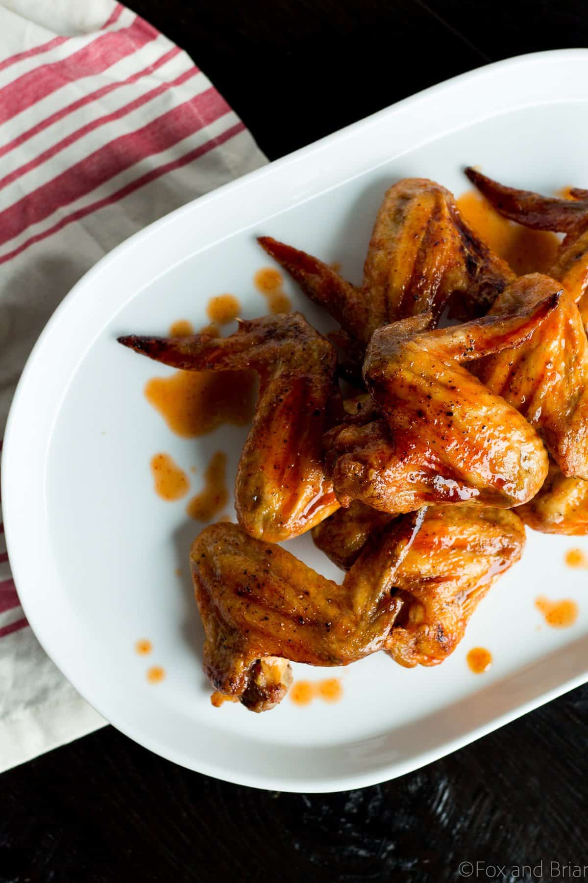 These Sriracha Brown Sugar Baked Wings are a little sweet, a little spicy and a little tangy. They get amazingly crispy in the oven, then finish with the sriracha brown sugar glaze that is totally mouthwatering and addictive!