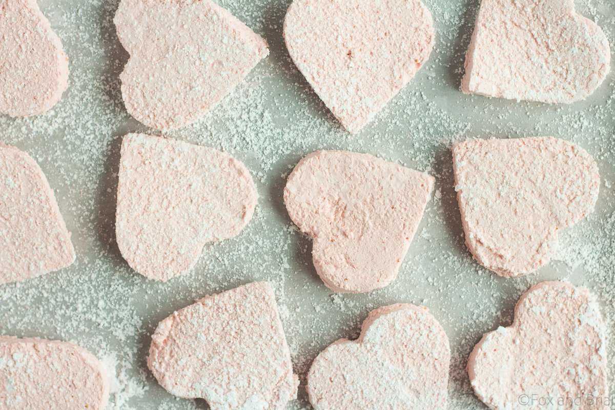 These Homemade Strawberry Marshmallows are fun and simple to make, and have amazing strawberry flavor. No high fructose corn syrup or dyes! A fun treat for Valentine's day or any other time of year!.