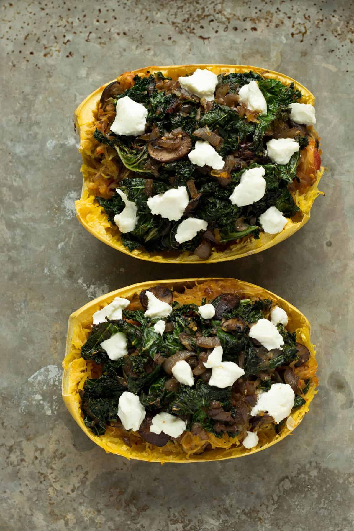 These veggie spaghetti squash boats are vegetarian, with kale, mushrooms and goat cheese. So packed with flavor and super healthy!