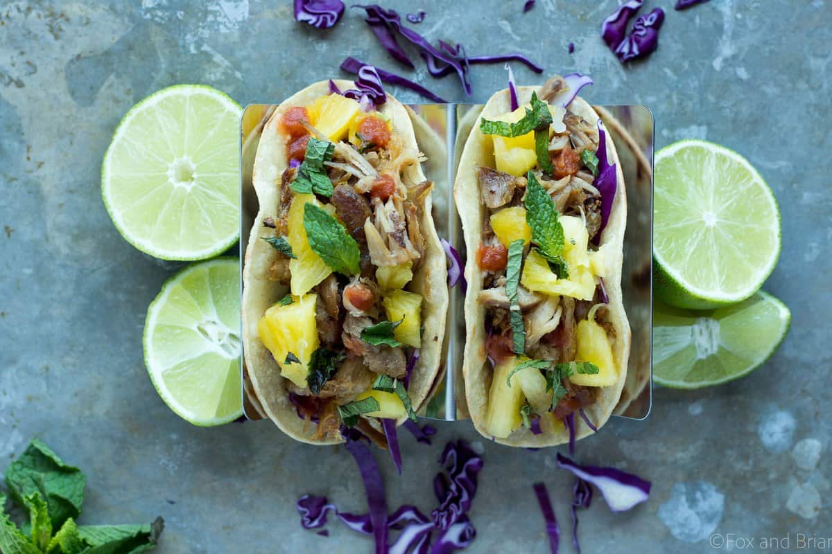 These Slow Cooker Pork Tacos let your slow cooker do most of the work. Crunchy purple cabbage, tender pork and a juicy pineapple mint salsa create a taco bursting with flavor!