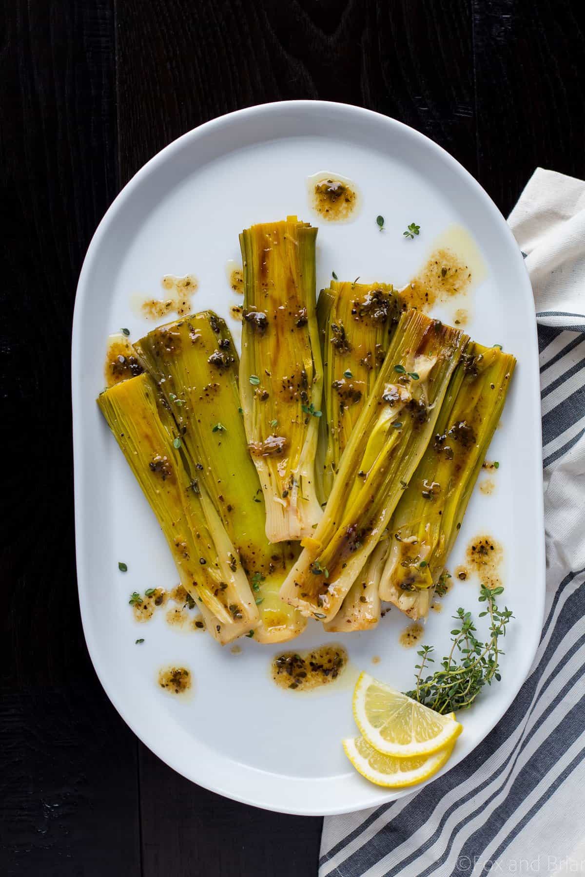 These Braised Leeks make the perfect spring side dish. They have a sweeter, more mild flavor than onions, and are caramelized before being cooked in a butter, white wine and lemon sauce. You and your guests won't be able to stop eating them!