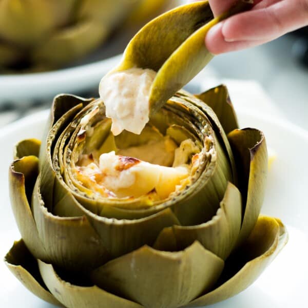 These Hot Crab Dip Stuffed Artichokes deserves a spot on your holiday or party table! Artichokes stuffed with a rich and cheesy crab dip, then baked until melty. You can use the artichoke leaves to scoop the dip!