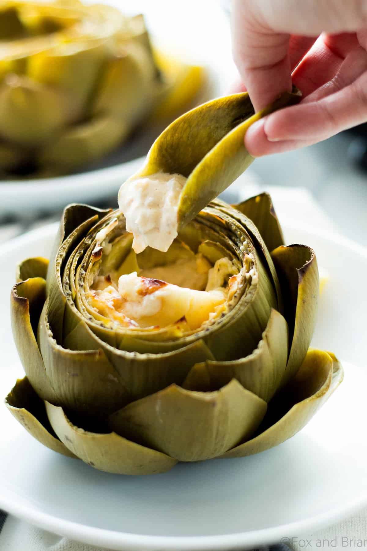 These Hot Crab Dip Stuffed Artichokes deserves a spot on your holiday or party table! Artichokes stuffed with a rich and cheesy crab dip, then baked until melty. You can use the artichoke leaves to scoop the dip!