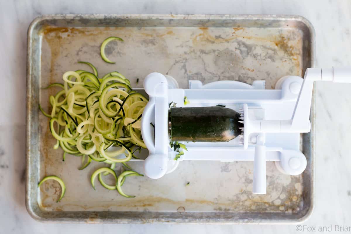 Zoodles (zuchinni noodles) quick cooked with asparagus, prosciutto, parmesan cheese, lemon and white wine all topped with a poached egg make a quick and light spring meal.