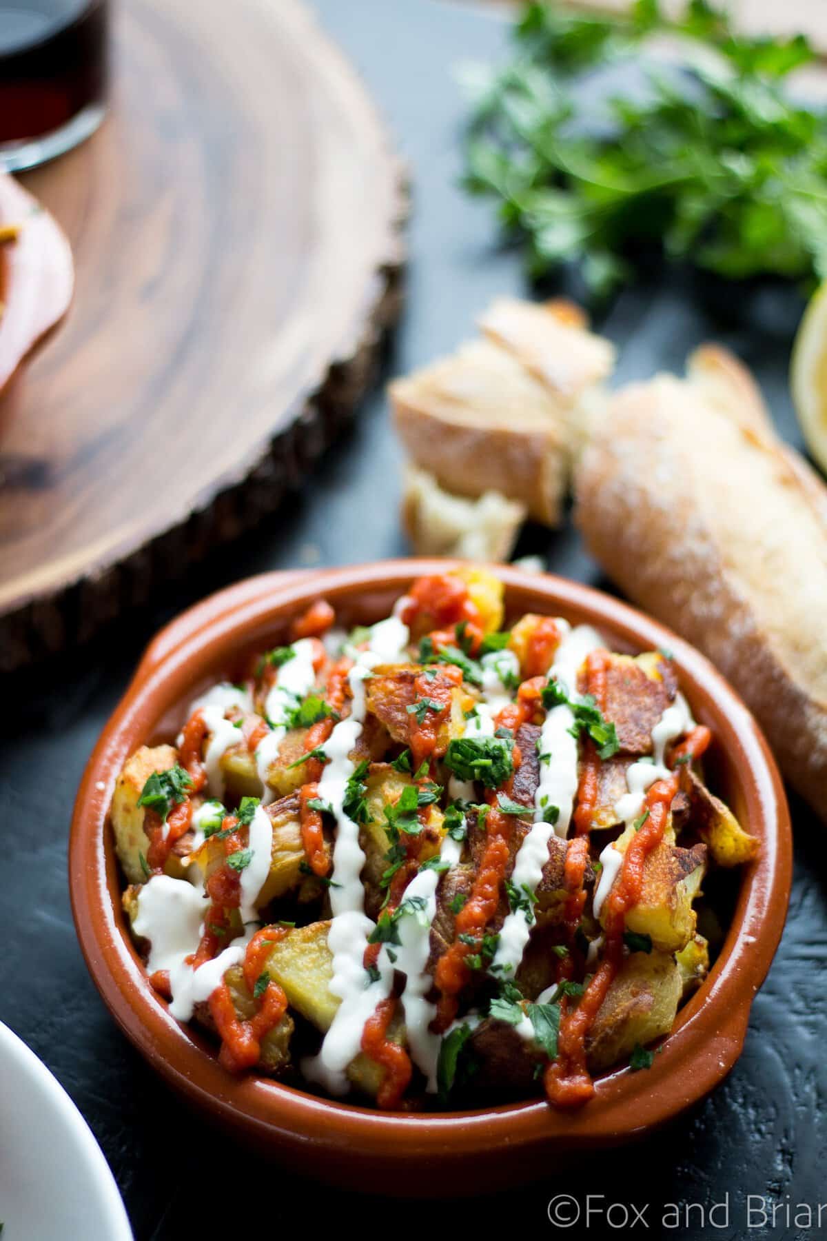 These patatas bravas are crispy even though they are baked not fried! Topped with a delicious smoky salsa brava and garlic aioli, they are totally addictive!