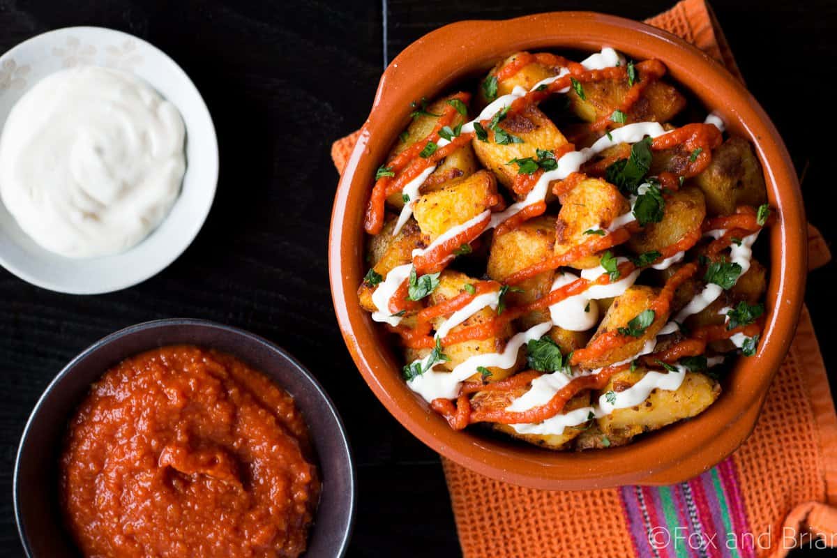 These patatas bravas are crispy even though they are baked not fried! Topped with a delicious smoky salsa brava and garlic aioli, they are totally addictive!