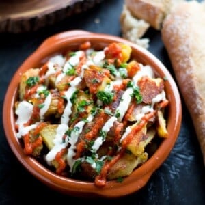 These patatas bravas are crispy even though they are baked not fried! Topped with a delicious smoky salsa brava and garlic aioli, they are totally addictive!