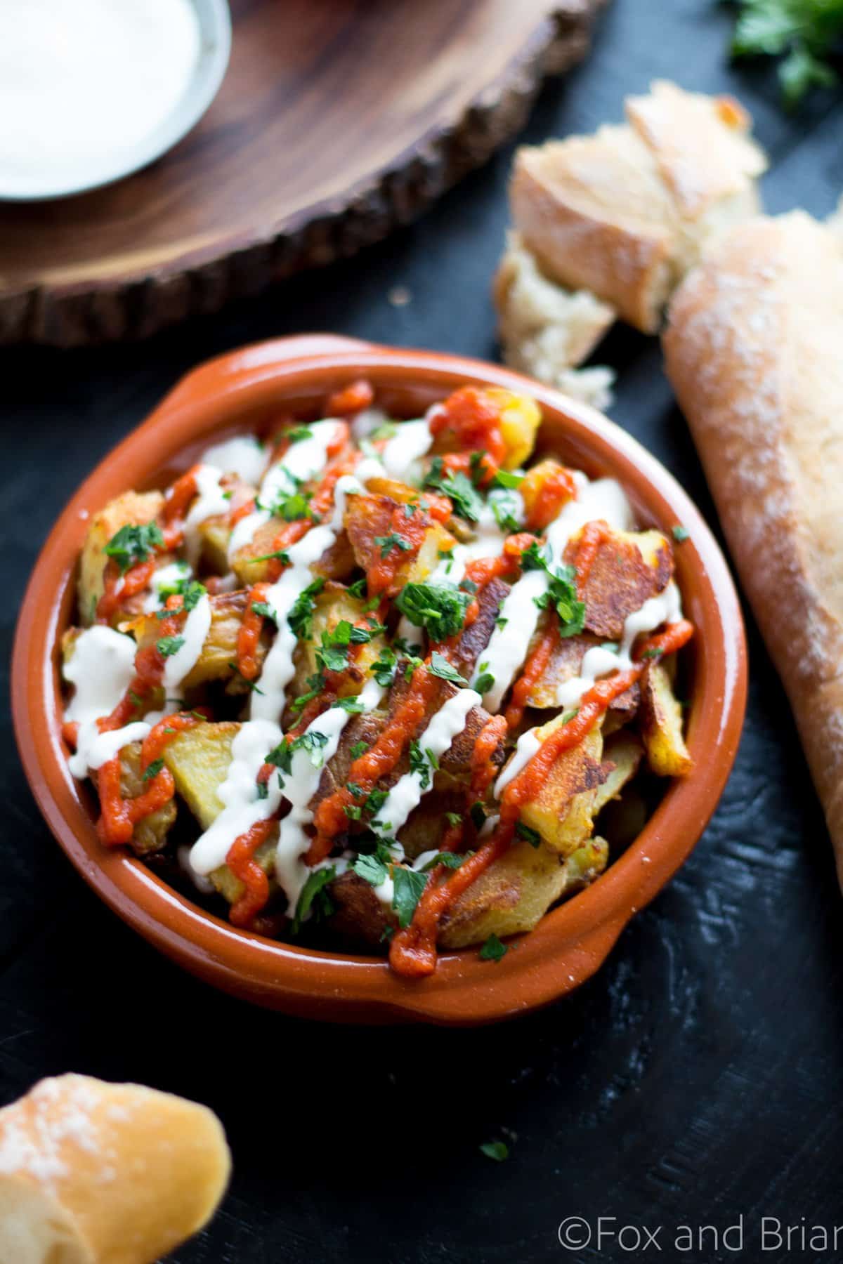 These patatas bravas are crispy even though they are baked not fried! Topped with a delicious smoky salsa brava and garlic aioli, they are totally addictive!