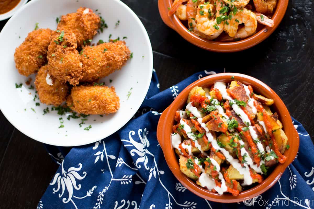 These patatas bravas are crispy even though they are baked not fried! Topped with a delicious smoky salsa brava and garlic aioli, they are totally addictive!