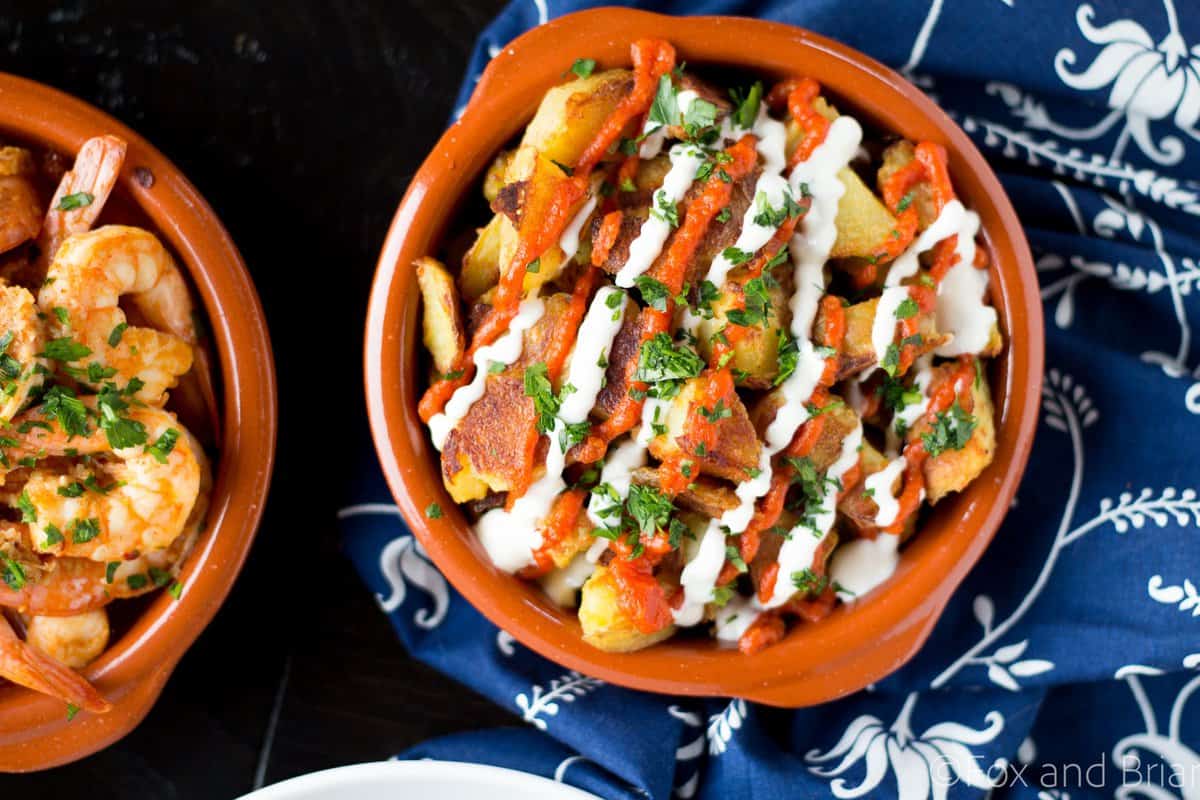 These patatas bravas are crispy even though they are baked not fried! Topped with a delicious smoky salsa brava and garlic aioli, they are totally addictive!