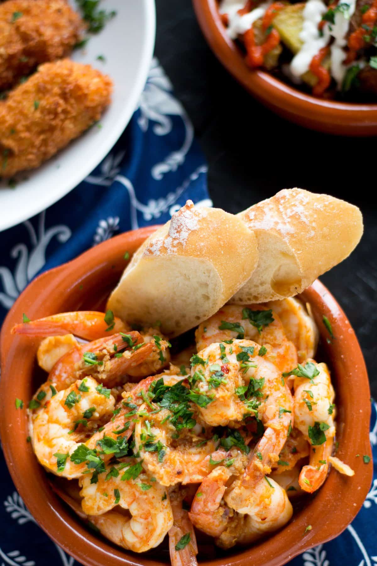 Garlic Shrimp (Gambas al Ajillo) are a classic Spanish tapas dish. Succulent shrimp in a spicy garlicky sauce that you will need to dip your bread into!