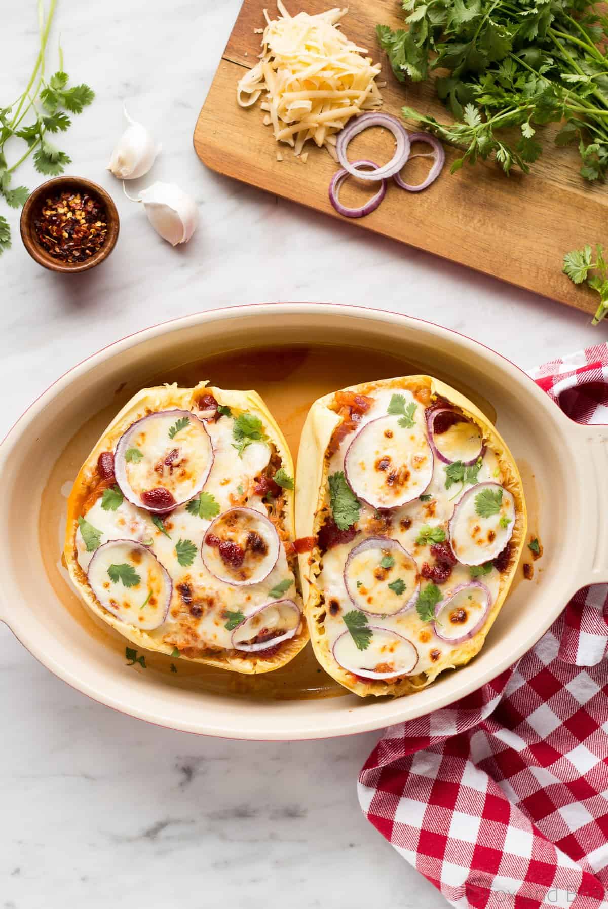 These BBQ Chicken Pizza Spaghetti Squash boats have all the delicious flavors of a BBQ Chicken Pizza - sweet and savory BBQ chicken, red onions and two kinds of cheese, stuffed in a spaghetti squash boat!