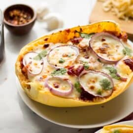 These BBQ Chicken Pizza Spaghetti Squash boats have all the delicious flavors of a BBQ Chicken Pizza - sweet and savory BBQ chicken, red onions and two kinds of cheese, stuffed in a spaghetti squash boat!