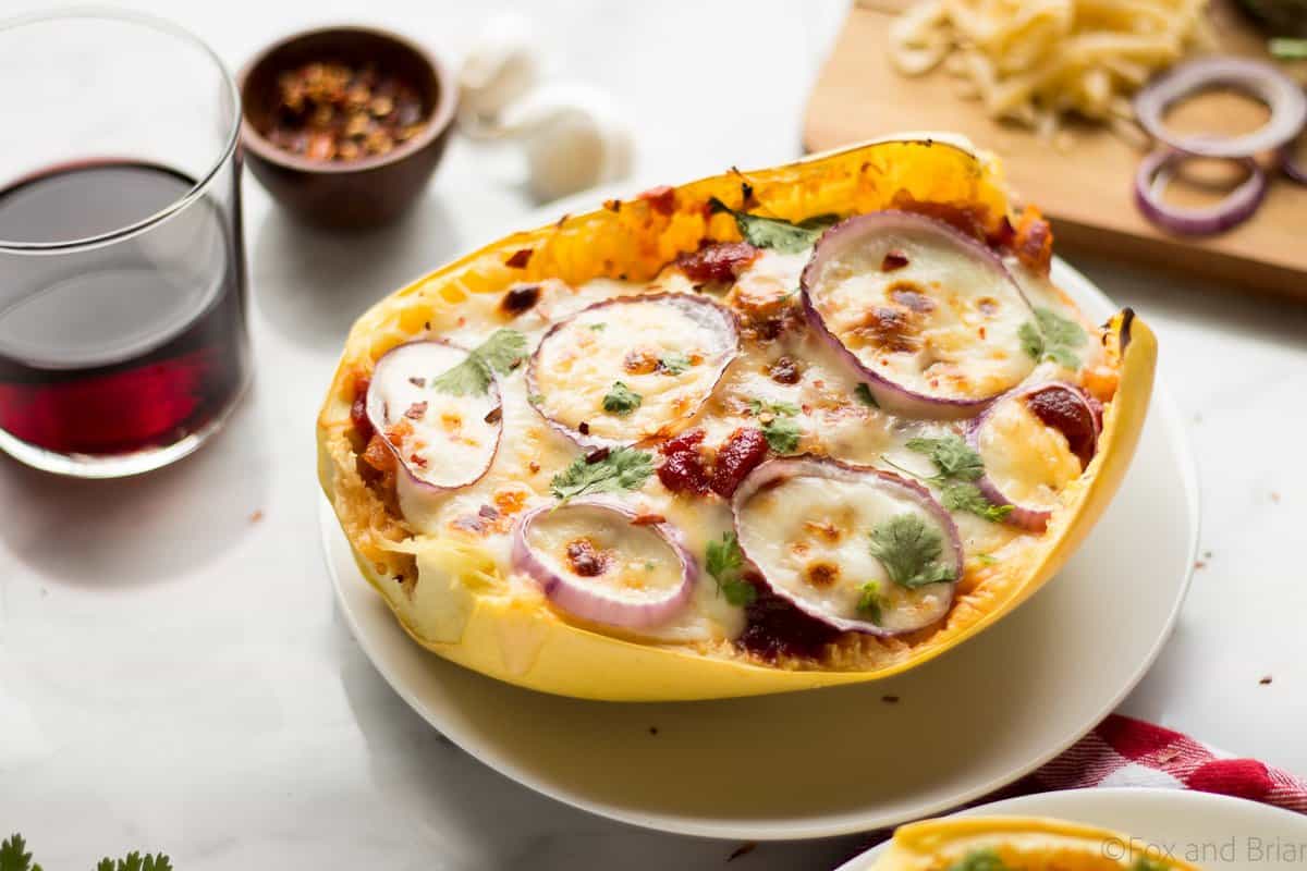 These BBQ Chicken Pizza Spaghetti Squash boats have all the delicious flavors of a BBQ Chicken Pizza - sweet and savory BBQ chicken, red onions and two kinds of cheese, stuffed in a spaghetti squash boat!