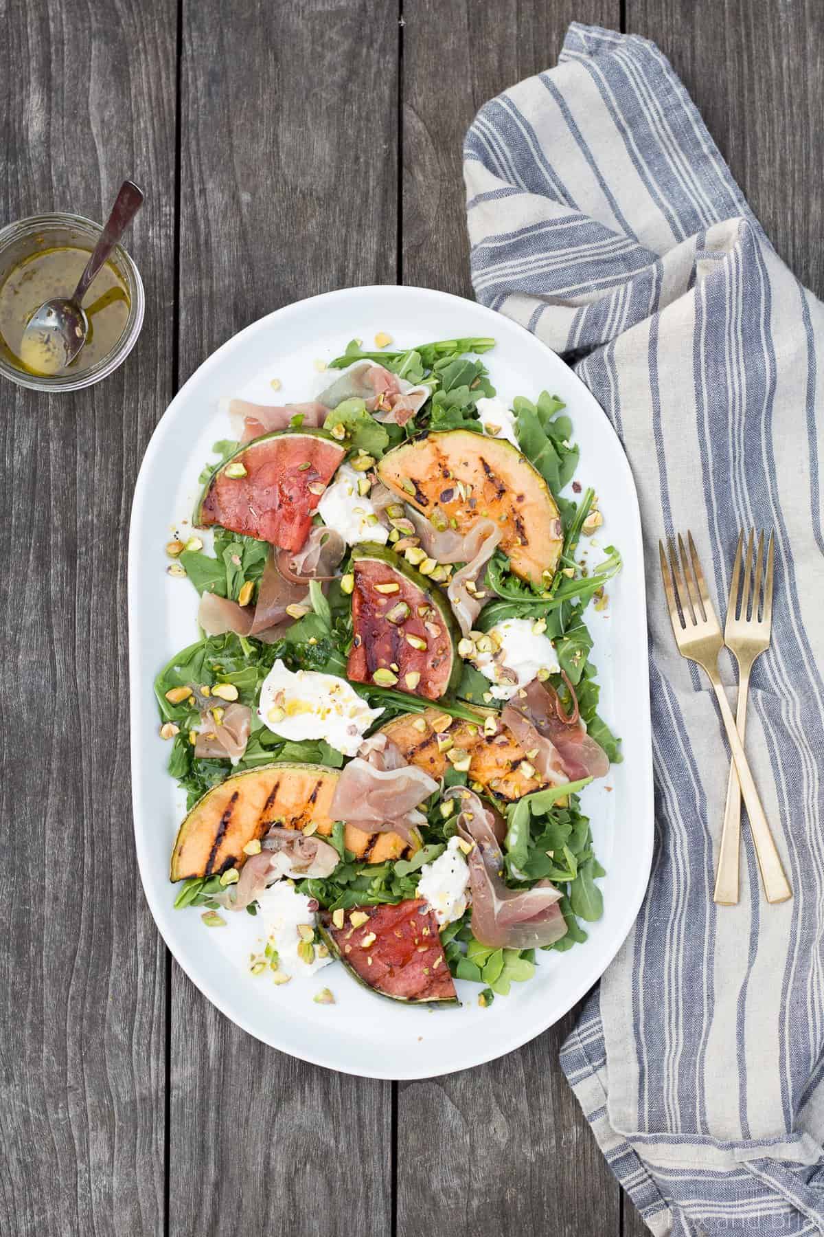 This Grilled Melon Salad with Prosciutto and Burrata is a light dinner perfect for a hot summer day!