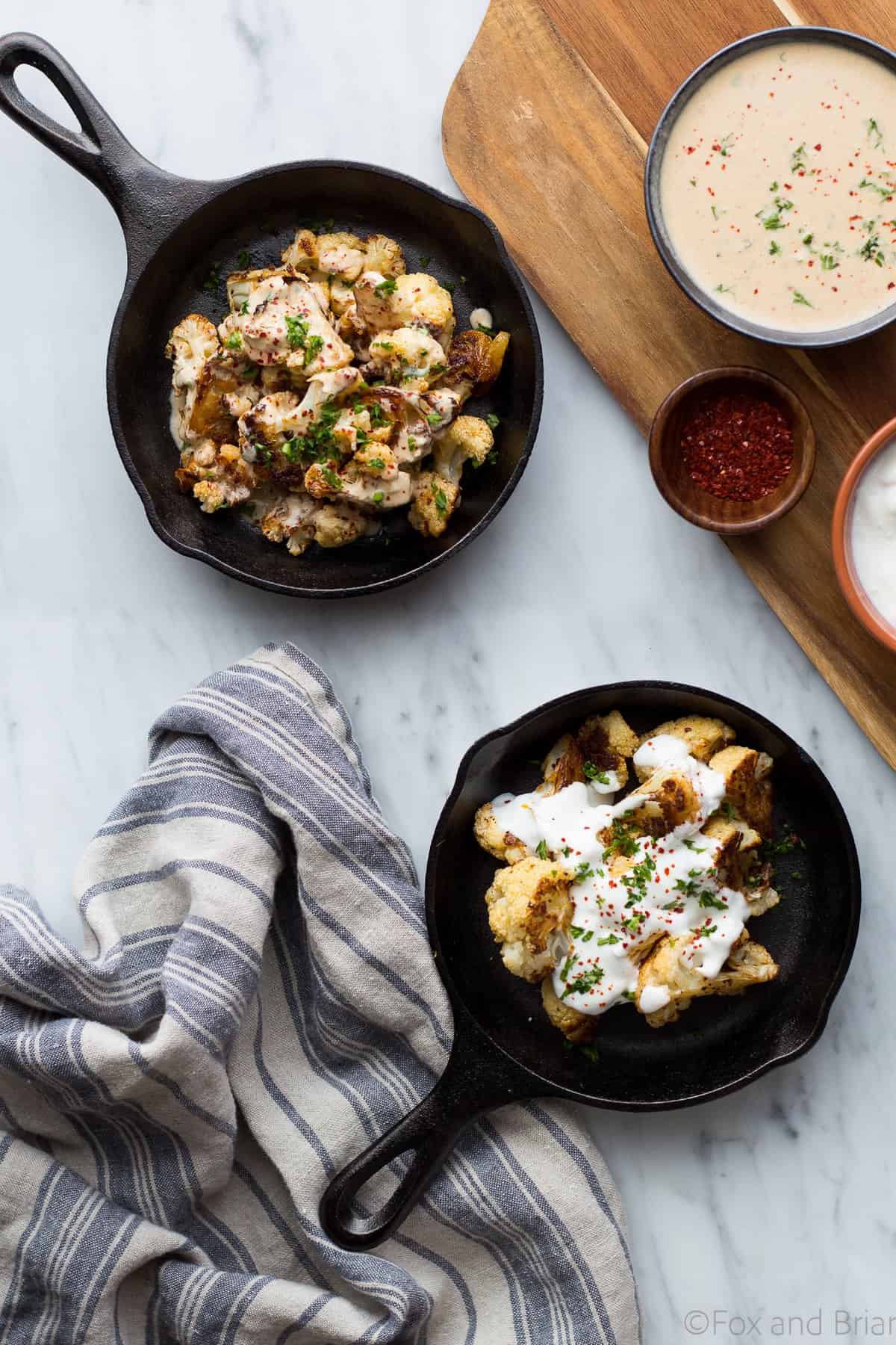 Roasted Cauliflower With Yogurt Sauce AND a dairy free tahini sauce! You won't beleive how addictive this dish is with caramelized cauliflower, a zingy yogurt sauce and a tasty tahini sauce for peope who prefer not to eat dairy.