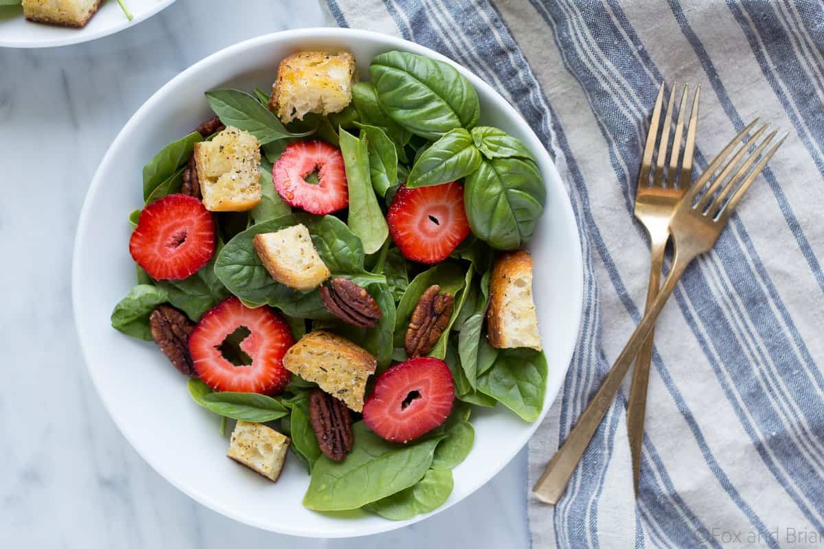 This Strawberry Basil Pecan Salad with Goat Cheese Dressing is a sweet and tangy summer salad bursting with fresh flavors and homemade croutons.