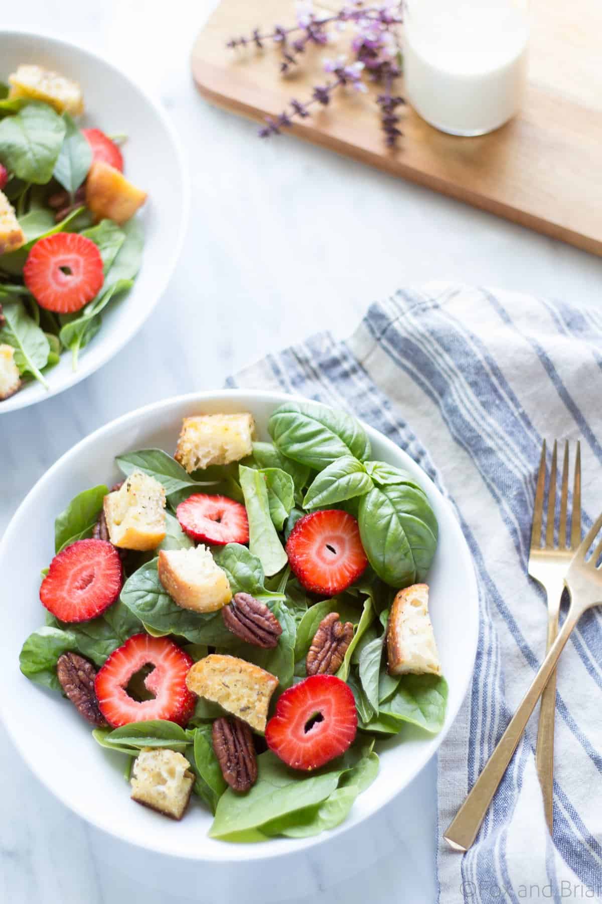 This Strawberry Basil Pecan Salad with Goat Cheese Dressing is a sweet and tangy summer salad bursting with fresh flavors and homemade croutons.