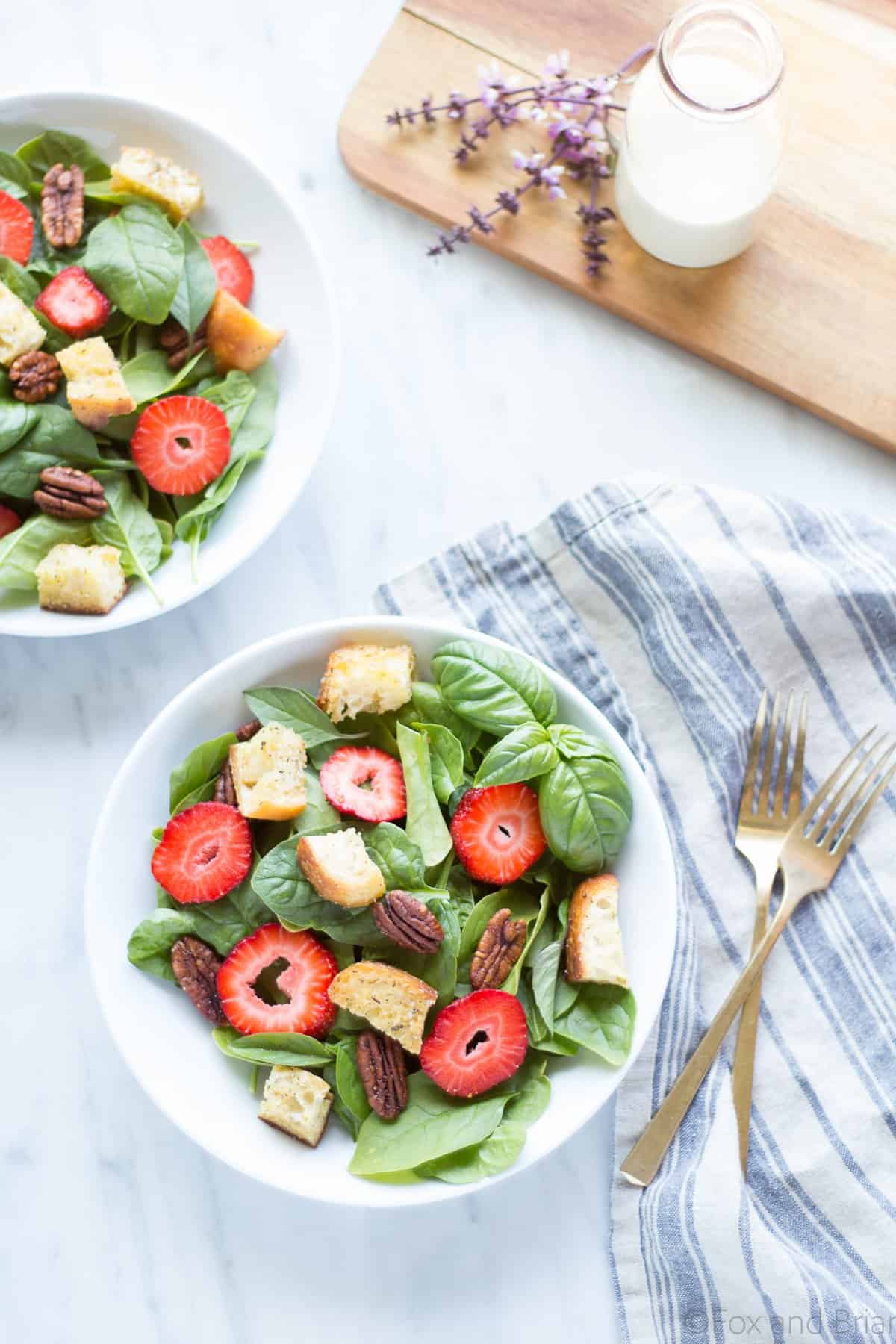 This Strawberry Basil Pecan Salad with Goat Cheese Dressing is a sweet and tangy summer salad bursting with fresh flavors and homemade croutons.