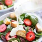 This Strawberry Basil Pecan Salad with Goat Cheese Dressing is a sweet and tangy summer salad bursting with fresh flavors and homemade croutons.