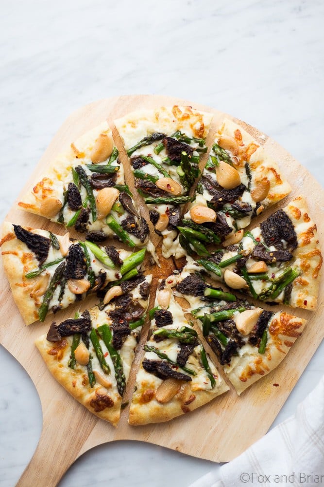 This Asparagus and Morel Pizza with Garlic Confit is the perfect way to use your spring produce! Garlicky and cheesey, packed full of flavor and vegetarian!