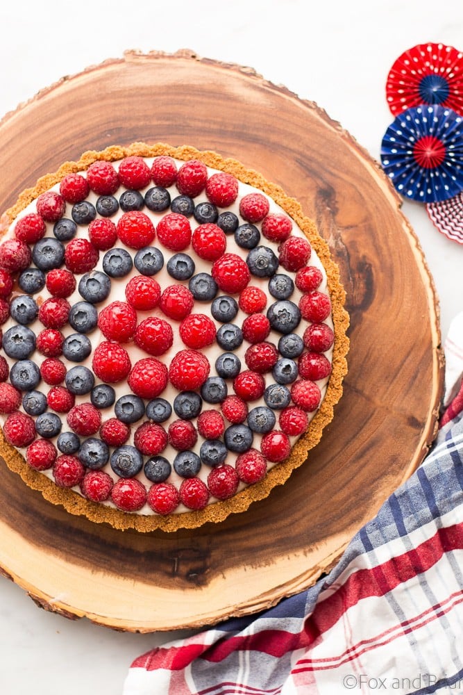 This Red, White and Blueberry Tart is a fresh berry tart perfect for 4th of July or any summer day! Fresh berries, a sweet creamy filling and a graham cracker crust make this simple and delicious tart a total winner!