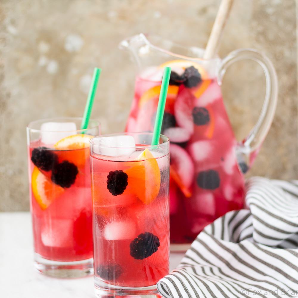 This Berry Sangria Iced Tea is a take on the Starbucks drink! Herbal iced tea mixed with a berry orange syrup, apple juice and blackberries! So refreshing for a hot summer day.