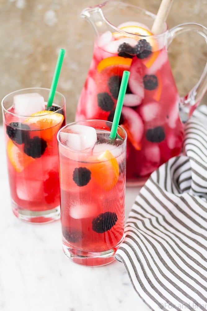 This Berry Sangria Iced Tea is a take on the Starbucks drink! Herbal iced tea mixed with a berry orange syrup, apple juice and blackberries! So refreshing for a hot summer day.