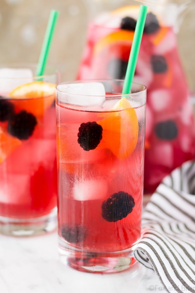 This Berry Sangria Iced Tea is a take on the Starbucks drink! Herbal iced tea mixed with a berry orange syrup, apple juice and blackberries! So refreshing for a hot summer day.