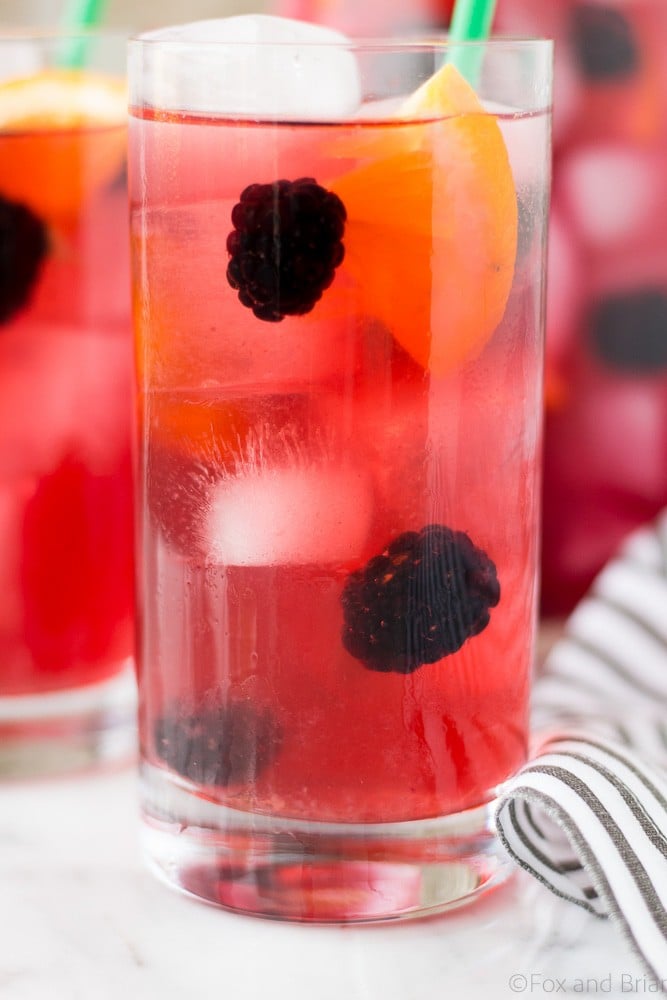 This Berry Sangria Iced Tea is a take on the Starbucks drink! Herbal iced tea mixed with a berry orange syrup, apple juice and blackberries! So refreshing for a hot summer day.