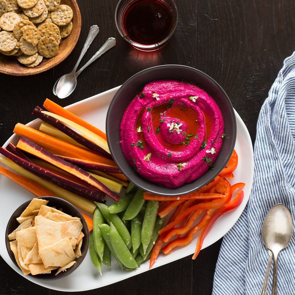 This Creamy Beet Hummus with Yogurt will soon be your favorite way to eat your beets! Roasted beets, tahini and yogurt are blended together to make a creamy and healthy dip with a bright pink color that will blow your mind!